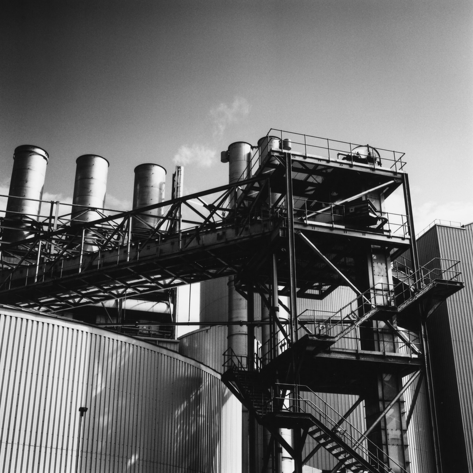 Stairways and walkways climbing the maltings beside its chimneys