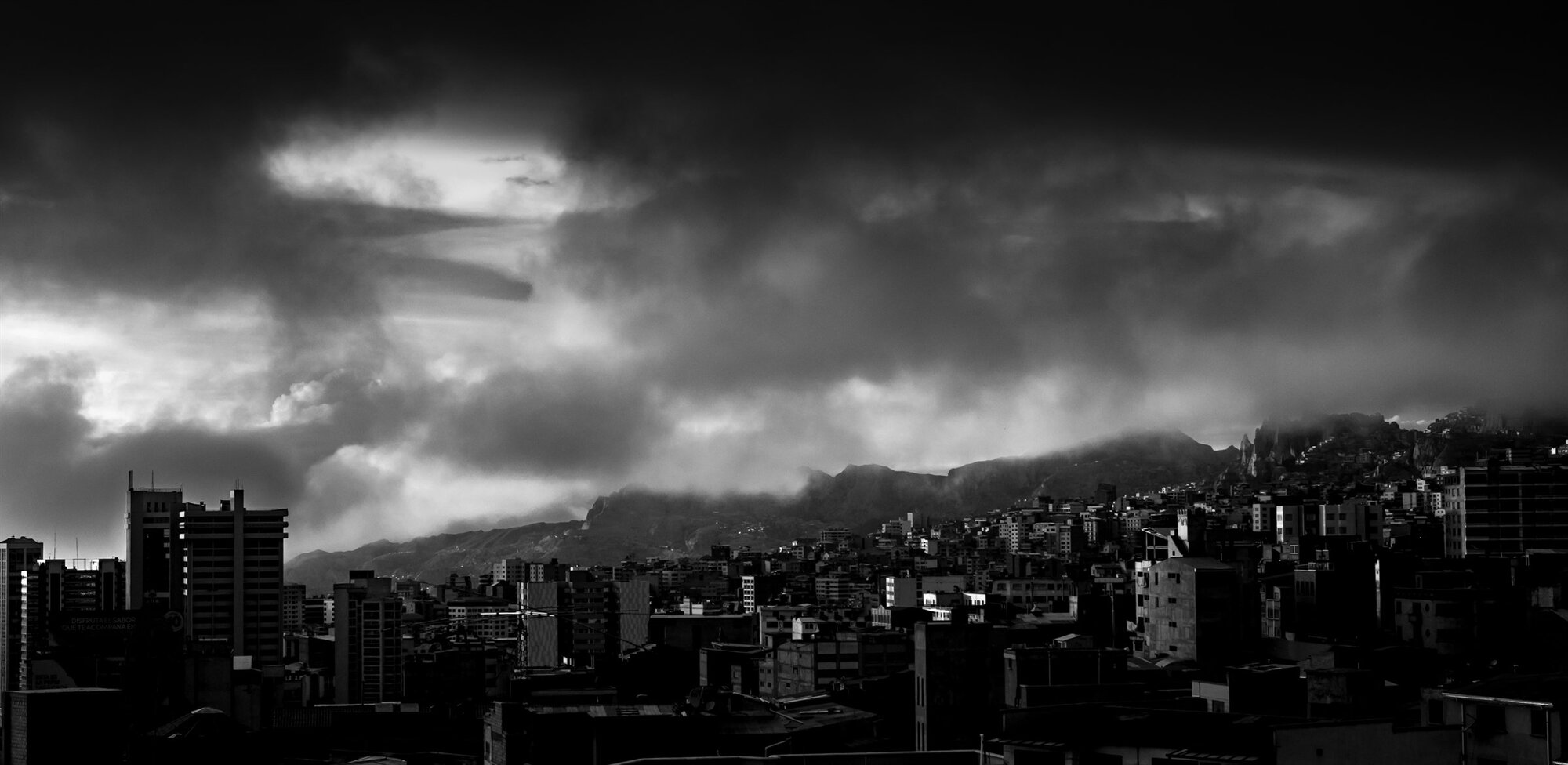 The La Paz skyline beneath dark storm clouds