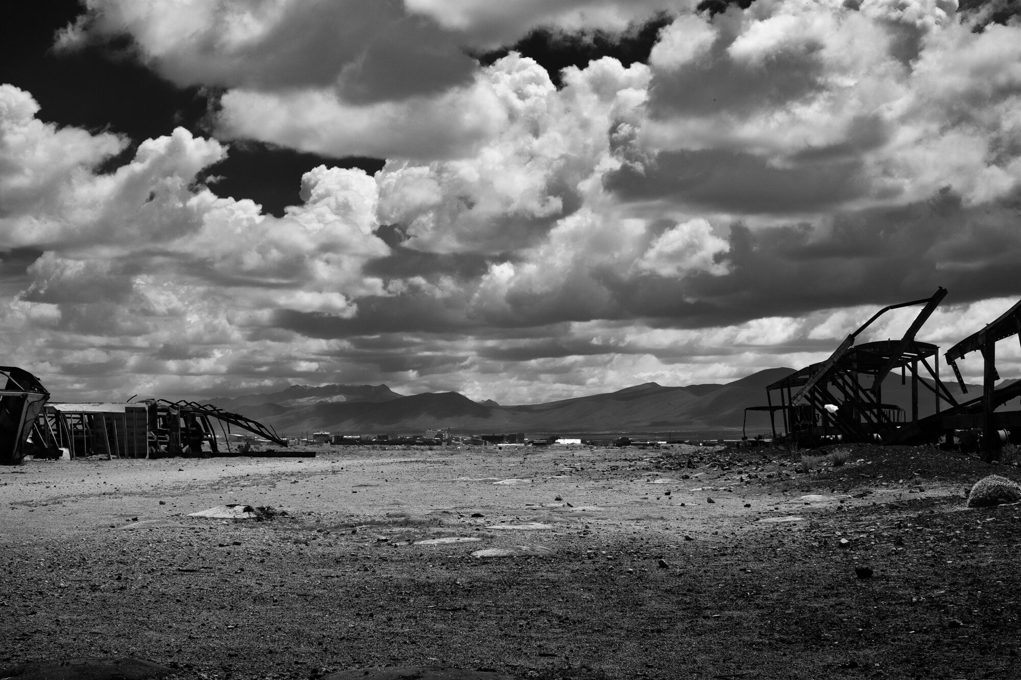 Clouds over the high plain beside a rusted wreck