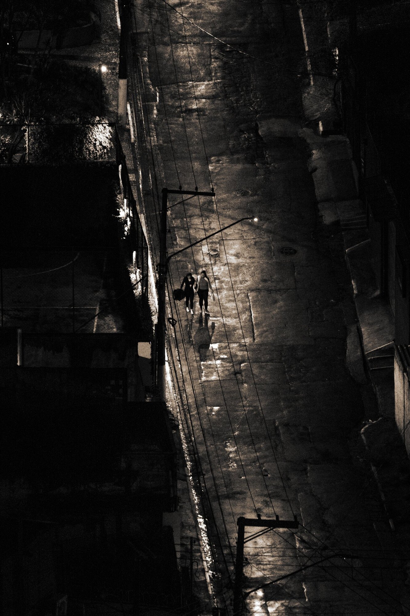 A narrow, shining wet alley in the dark