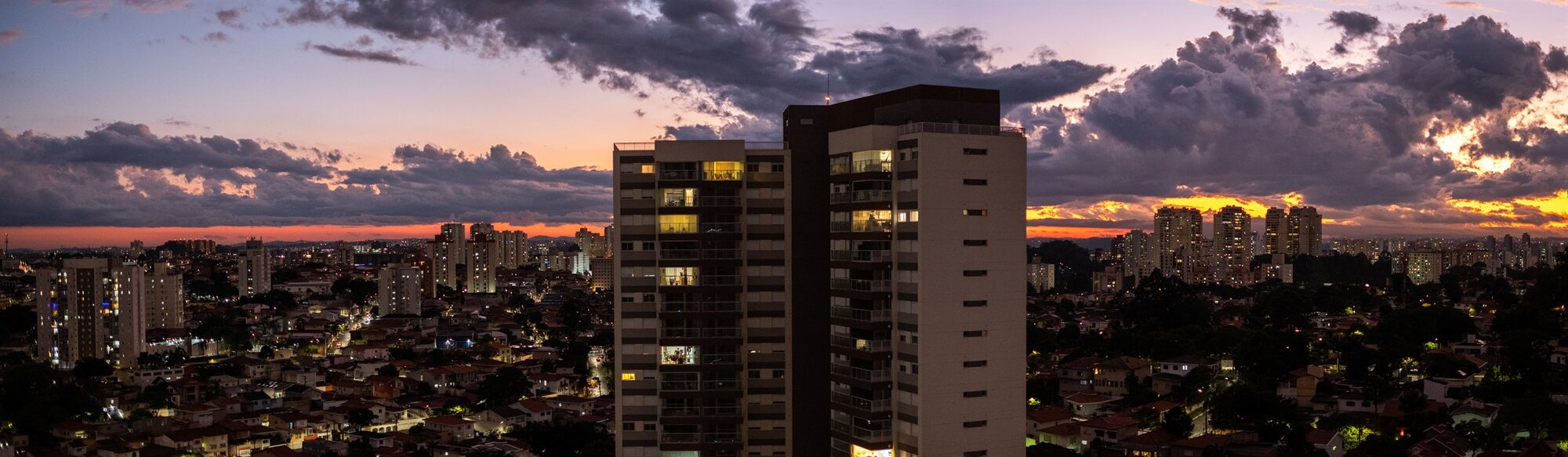 Tower blocks against a sunset sky
