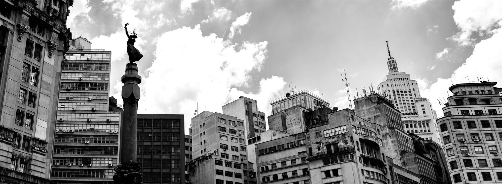 A monument and old buildings along a city square