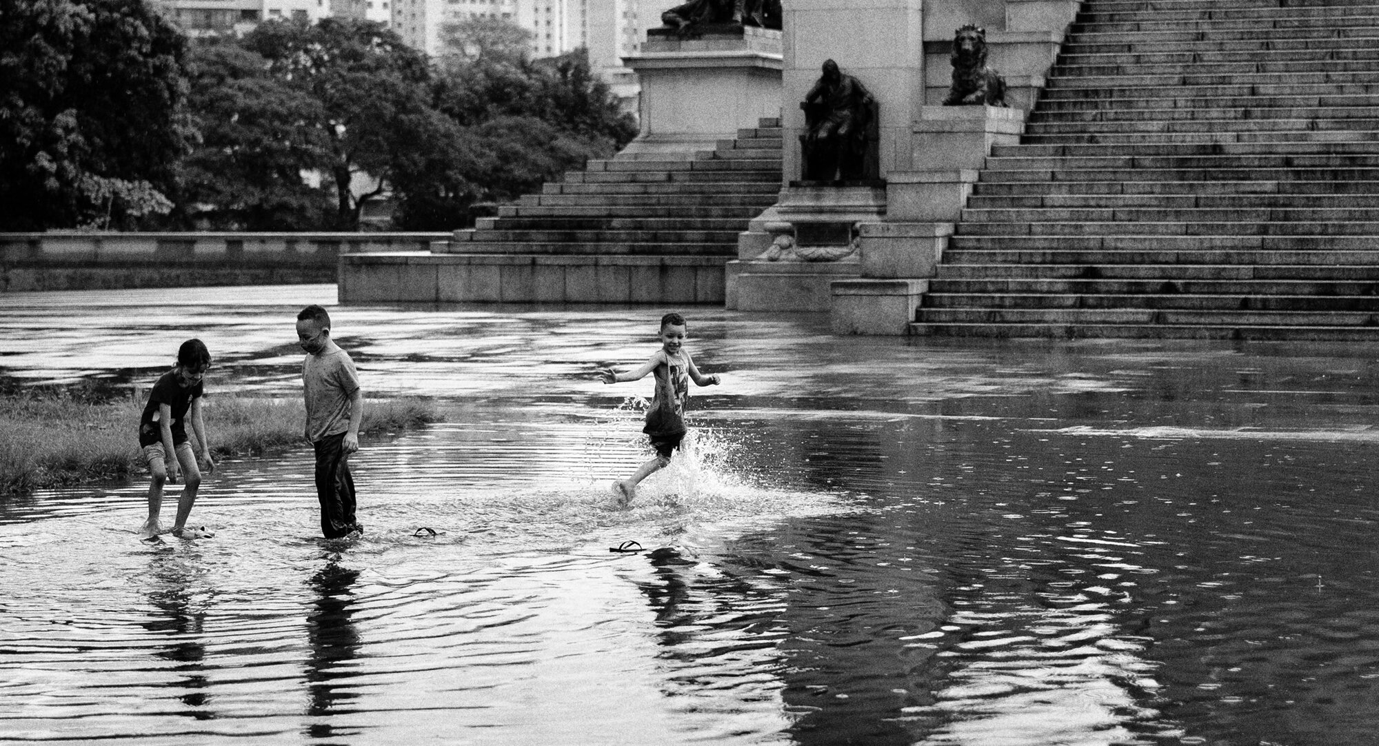 Children playing in shallow water by the steps