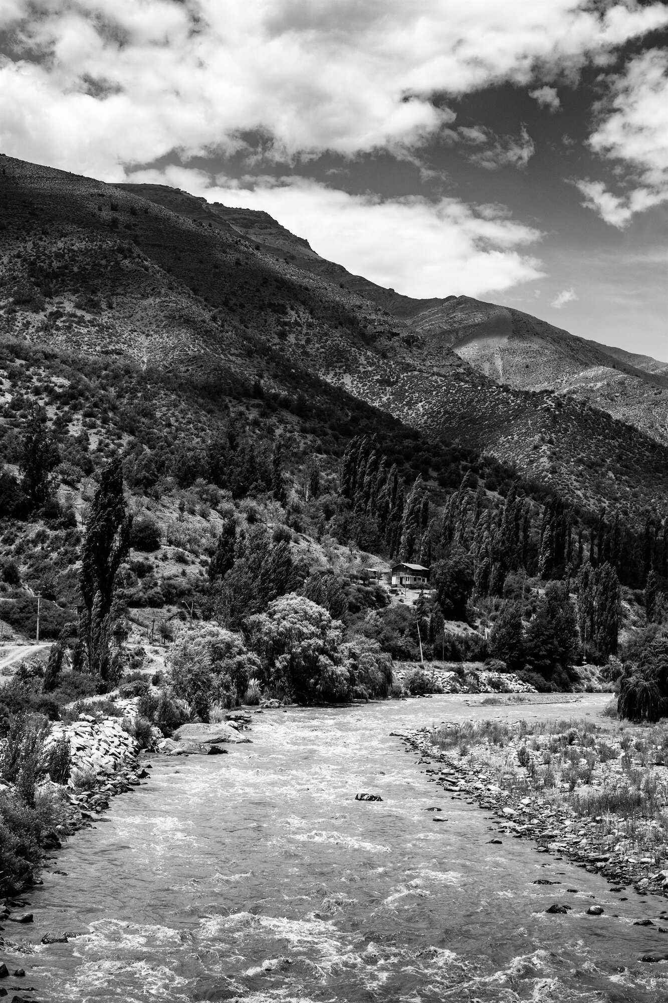 A river running through a wooded mountain valley