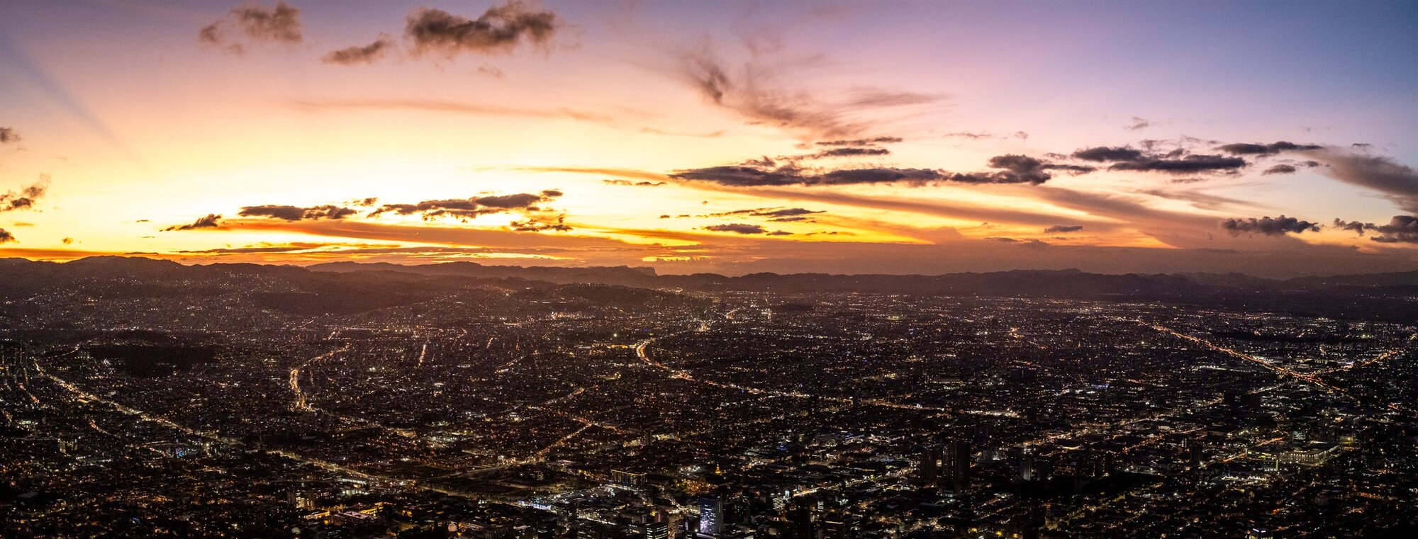 The lights of Medellín under a sunset sky