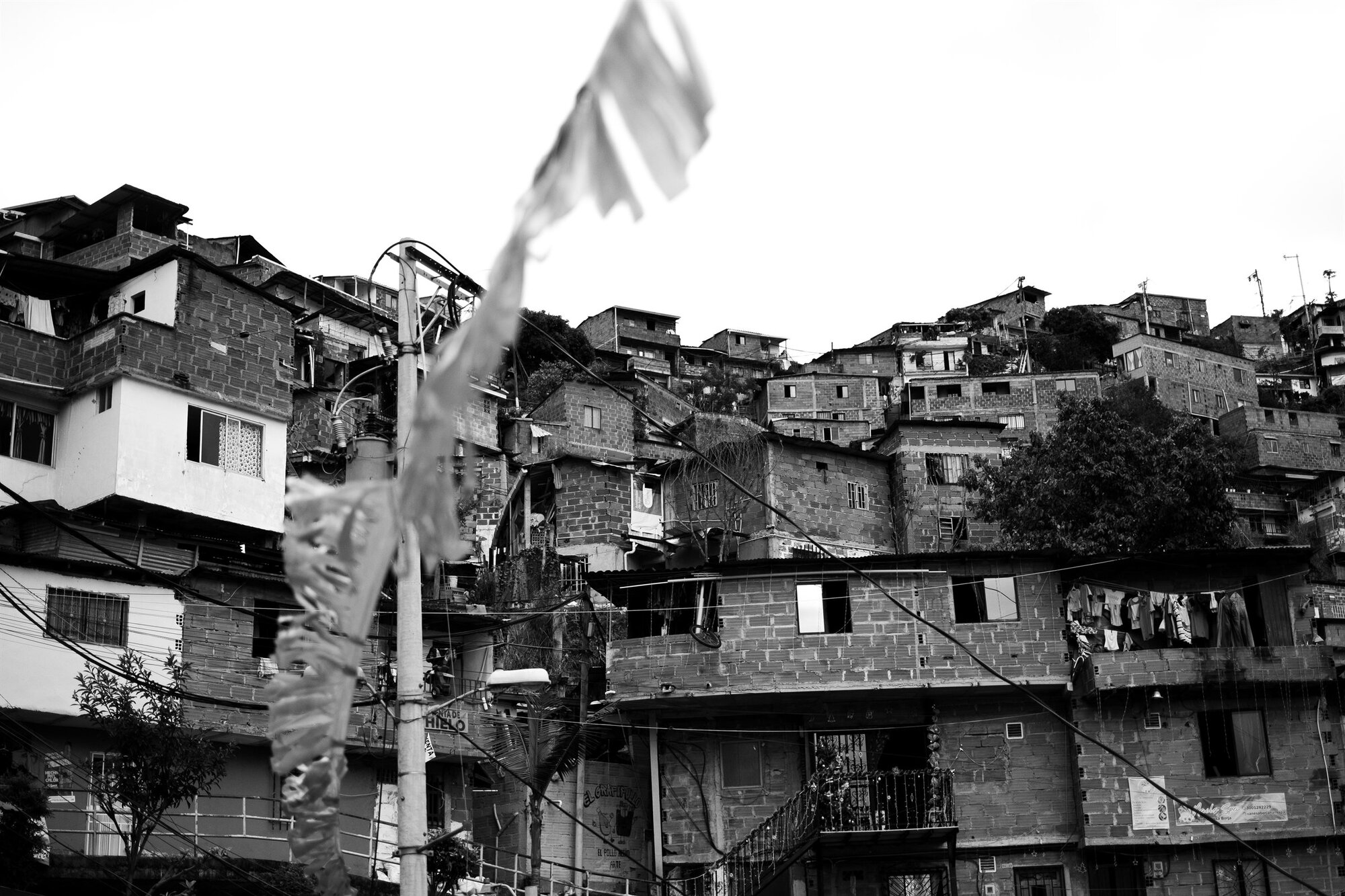 Brick houses stacked up a slope beneath a flag