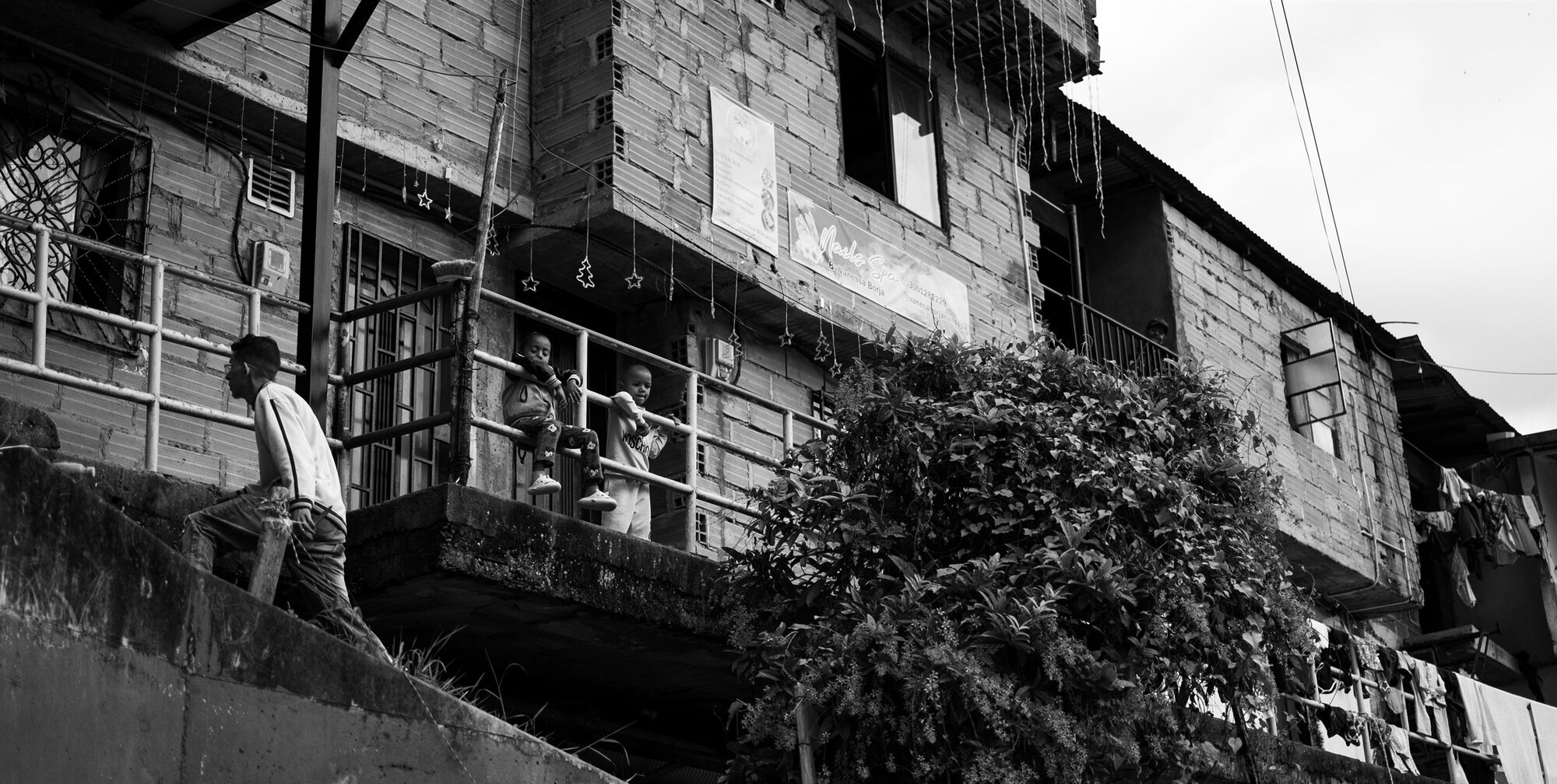A figure on the steps of a brick building